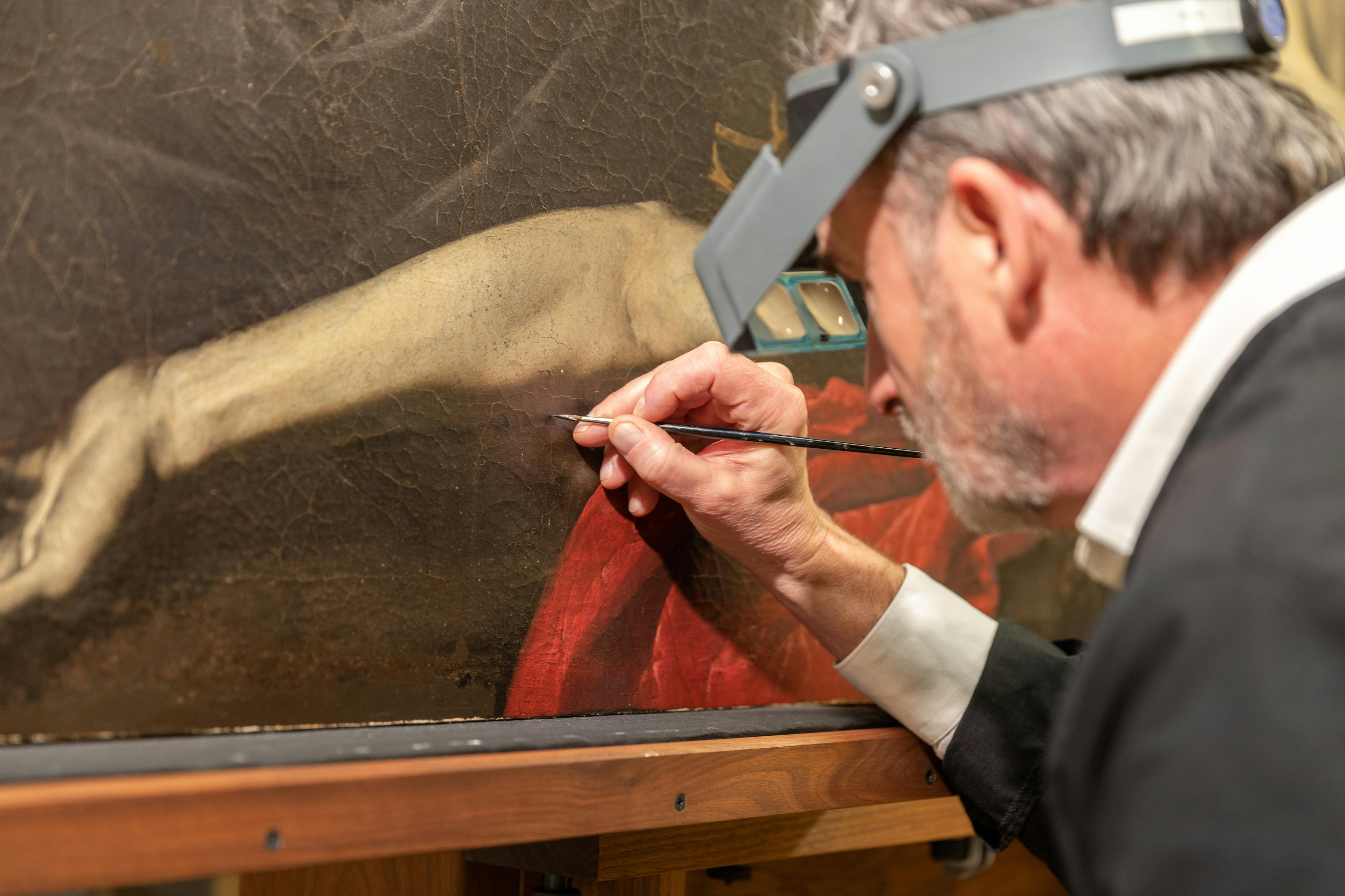 Dean Yoder inpainting in the CMA paintings conservation lab.